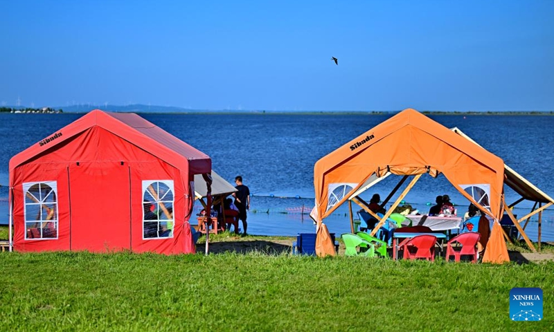 People cool off in tents by the Songhua River in Harbin, northeast China's Heilongjiang Province, July 6, 2025.
Attracted by the coolness in summer, many tourists come to Harbin for vacation.
Taking advantage of its historical heritage, Harbin in recent years has accelerated the transformation of historical and cultural blocks and the utilization of old buildings, which has promoted the prosperity of the city's tourism industry. Photo: Xinhua