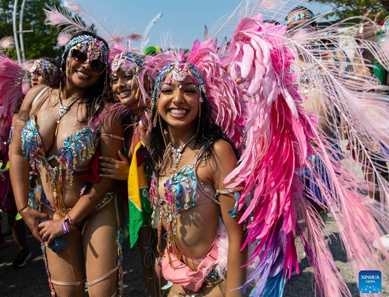 Dressed-up revelers pose for photos during the Grand Parade of the 2025 Toronto Caribbean Carnival in Toronto, Canada, on Aug. 2, 2025. This annual event was held here on Saturday to showcase Caribbean culture with thousands of masqueraders in stunning costumes. Photo: Xinhua