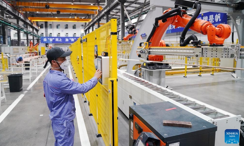 A worker operates intelligent numerical control device at a smart workshop of a coil factory in Harbin Electric Machinery Company Ltd. in Harbin, northeast China's Heilongjiang Province, July 24, 2025. (Xinhua/Wang Song)