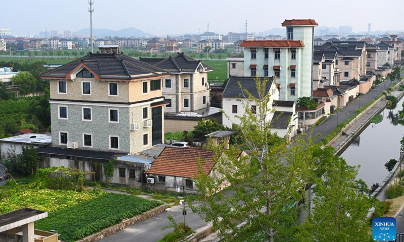 Residential buildings for villagers are pictured at Meilin Village in Xiaoshan District of Hangzhou, east China's Zhejiang Province, on Aug. 4, 2025. Meilin, which has long been a model village for rural development, has been actively exploring ways to reduce pollution and carbon emissions in recent years. Through a series of measures such as promoting rooftop photovoltaic projects, building smart farmlands and integrated photovoltaic charging and storage stations, clean energy is being widely adopted here, injecting green impetus for the rural revitalization. (Xinhua/Mao Zhu)