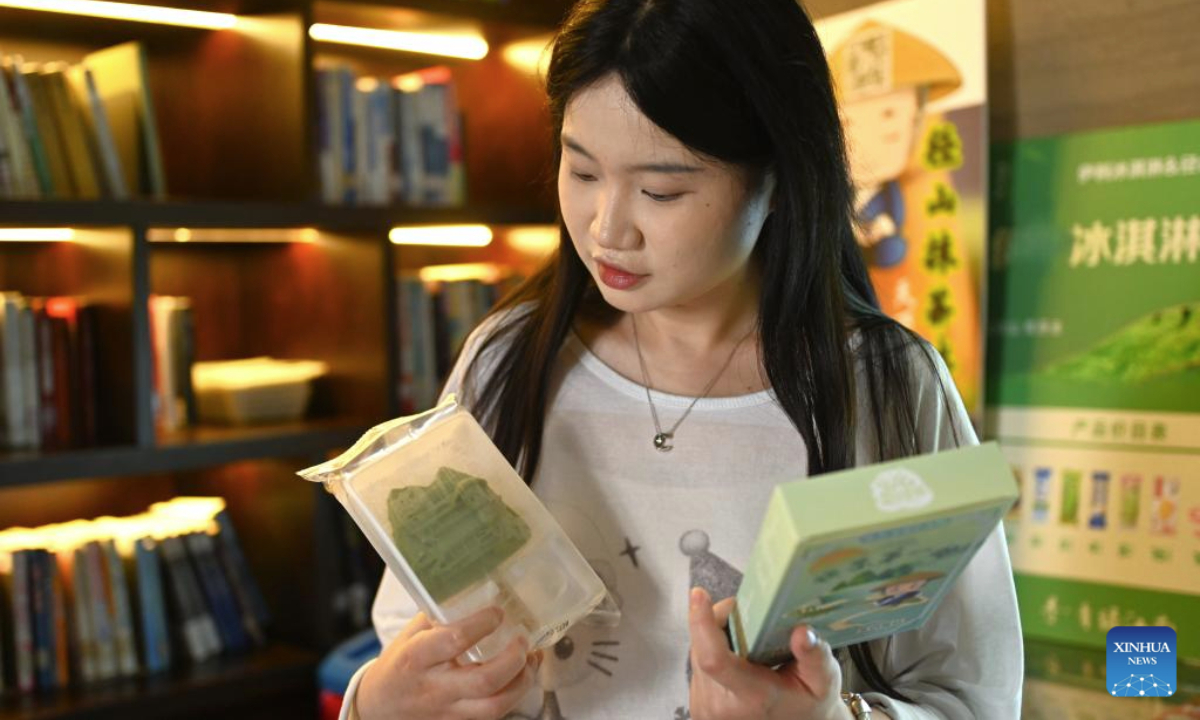 A tourist learns about a tea-flavoured popsicle at Jingshan Village in Yuhang District of Hangzhou City, east China's Zhejiang Province, Aug. 5, 2025. Jingshan Village, located in Yuhang District of Hangzhou City, east China's Zhejiang Province, is celebrated for its top-notch forest coverage rate of over 96 percent.

In recent years, the village has been boosting coordinated development of its tea industry and tourist service through creative projects such as digital tea gardens and low-carbon homestays, aiming to convert ecological advantages into economic propellers. (Xinhua/Mao Zhu)