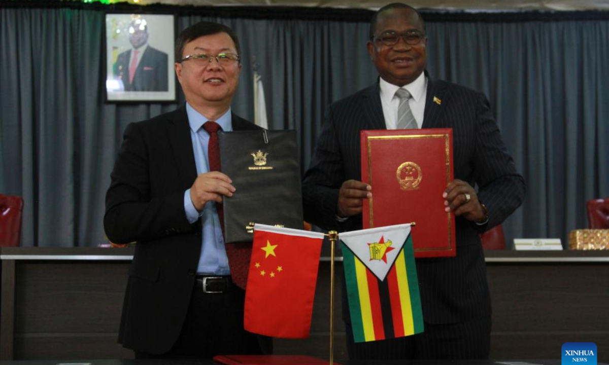 Chinese Ambassador to Zimbabwe Zhou Ding and Zimbabwean Minister of Finance and Economic Development Mthuli Ncube pose for a photo at a signing ceremony in Harare, Zimbabwe, Aug. 6, 2025. China and Zimbabwe on Wednesday signed an agreement on economic and technical cooperation and exchange of letters for a new batch of food assistance to boost Zimbabwe's socio-economic development and food security.(Photo by Tafara Mugwara/Xinhua)