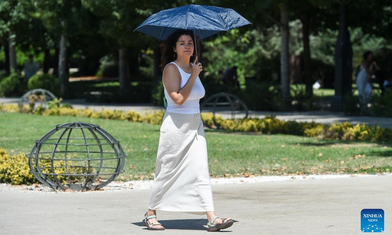 A woman uses an umbrella to shield herself from the sun in Madrid, Spain, Aug. 4, 2025. Heatstroke alerts were issued in many places across Spain as the country is hit by a searing heatwave. (Photo by Gustavo Valiente/Xinhua)