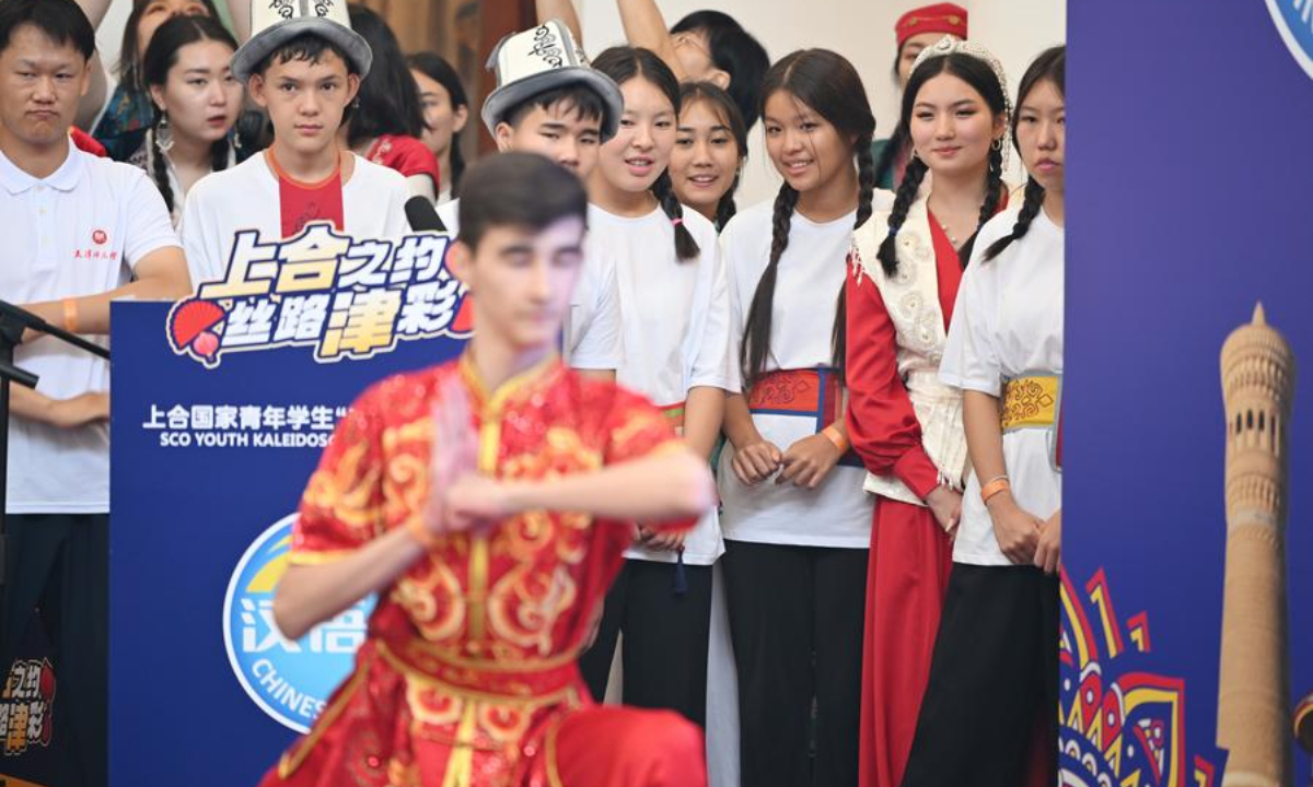 Young students from the Shanghai Cooperation Organization (SCO) countries watch a performance of Chinese traditional martial art during the Kaleidoscope Cultural Bazaar in north China's Tianjin, Aug. 6, 2025. (Xinhua/Li Ran)