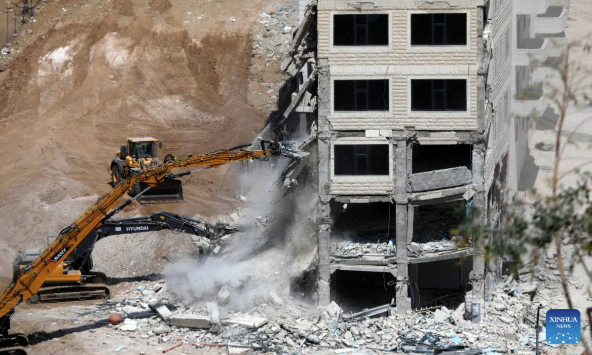 Israeli excavators demolish a building near Dar Salah, east of Bethlehem, in the southern West Bank, on Aug. 6, 2025. (Photo by Mamoun Wazwaz/Xinhua)