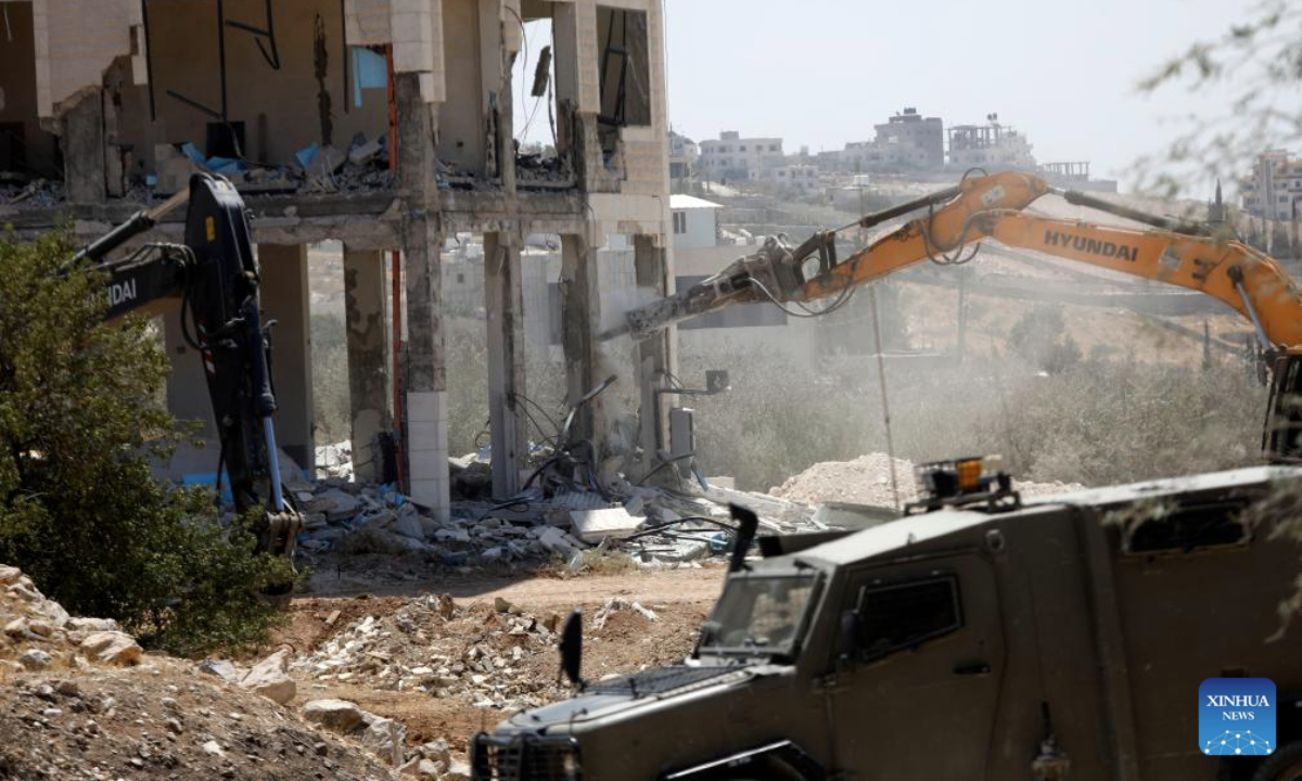 Israeli excavators demolish a building near Dar Salah, east of Bethlehem, in the southern West Bank, on Aug. 6, 2025. (Photo by Mamoun Wazwaz/Xinhua)