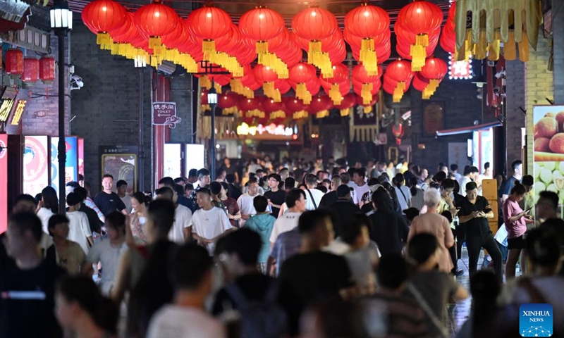 Tourists visit an ancient cultural street in north China's Tianjin Municipality, Aug. 3, 2025. Local shop-owners have extended operating hours and organized live performances to attract visitors, boosting the summer economy. (Xinhua/Zhao Zishuo)