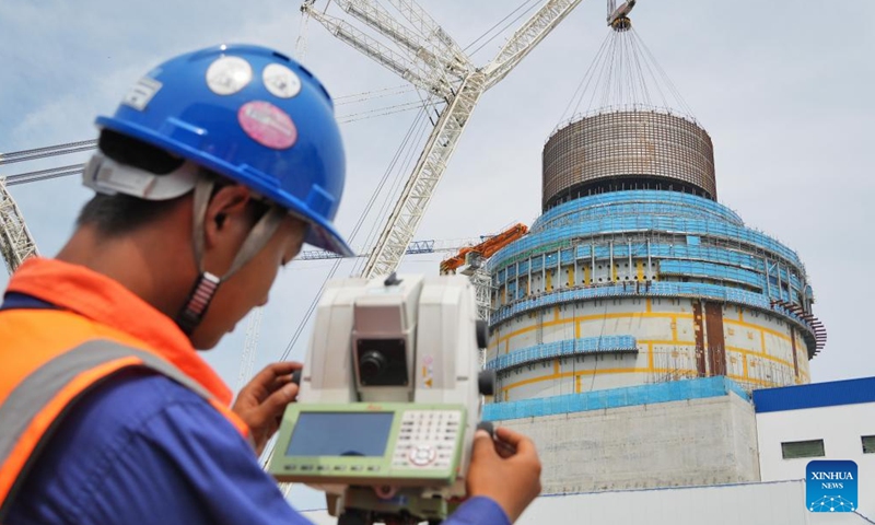 A staff member monitors a crane lifting the CB20 module of the nuclear island for the 3rd unit of the Haiyang Nuclear Power Plant in Haiyang, east China's Shandong Province, Aug. 4, 2025. The CB20 module was successfully lifted and positioned on Monday, marking the completion of all major module installations for the 3rd unit of the Haiyang Nuclear Power Plant and the start of equipment installation and commissioning phase. (Photo by Tang Ke/Xinhua)