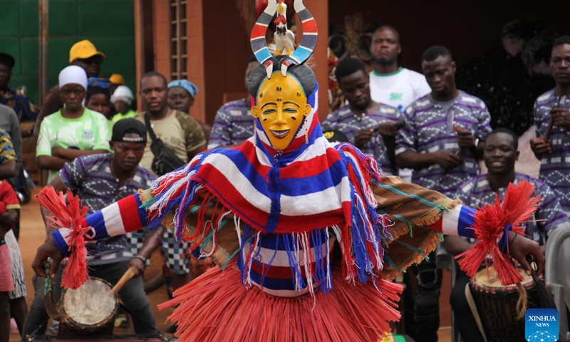 A person in costumes performs in a mask parade during the Porto Novo Mask Festival in Porto Novo, Benin, Aug. 3, 2025. The festival was held here from Saturday to Sunday to showcase the art and culture of Benin's traditional religion Vodun through a mask parade, concerts, seminars and other activities. (Photo by Seraphin Zounyekpe/Xinhua)
