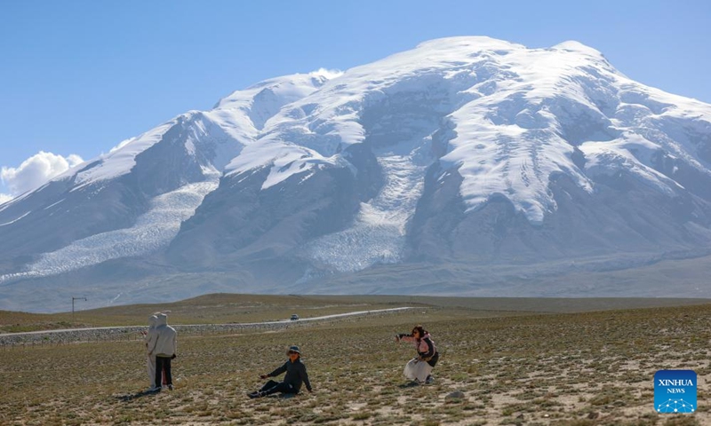 People visit the Muztagata glacier park in Tajik Autonomous County of Taxkorgan, northwest China's Xinjiang Uygur Autonomous Region, Aug. 3, 2025. Tajik Autonomous County of Taxkorgan has entered the peak travel season as more tourists come here to experience the culture and enjoy the scenery on the plateau. (Xinhua/Wang Fei)
