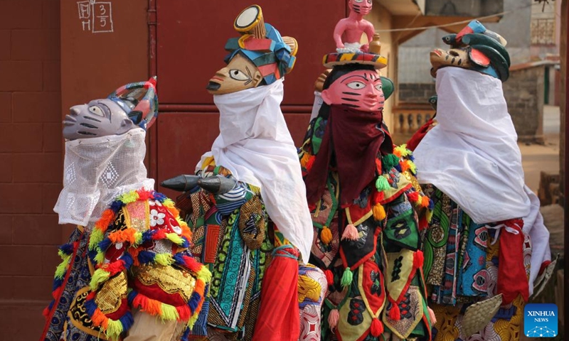 People in costumes perform in a mask parade during the Porto Novo Mask Festival in Porto Novo, Benin, Aug. 3, 2025. The festival was held here from Saturday to Sunday to showcase the art and culture of Benin's traditional religion Vodun through a mask parade, concerts, seminars and other activities. (Photo by Seraphin Zounyekpe/Xinhua)