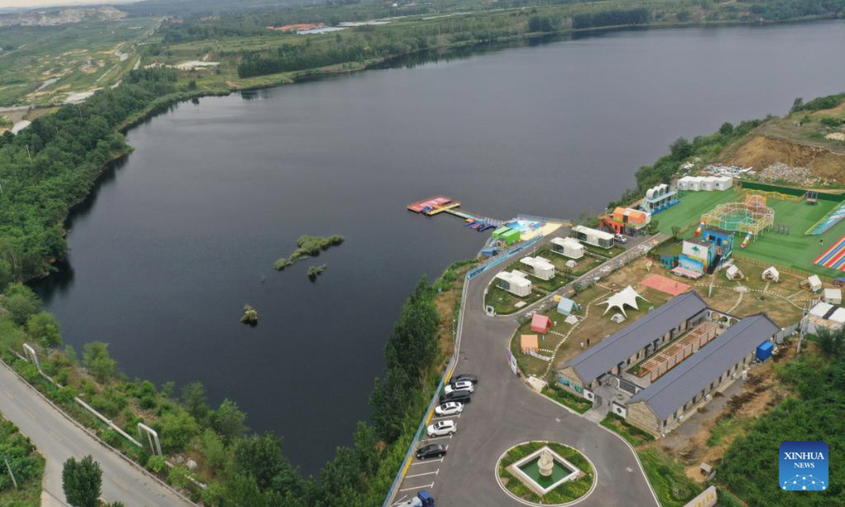 An aerial drone photo taken on Aug. 5, 2025 shows a resort which was once a mine pit in Laixi City, east China's Shandong Province. In recent years, local authorities have transformed a closed mine pit into a resort, a move to promote local ecological environment. (Xinhua/Ding Hongfa)