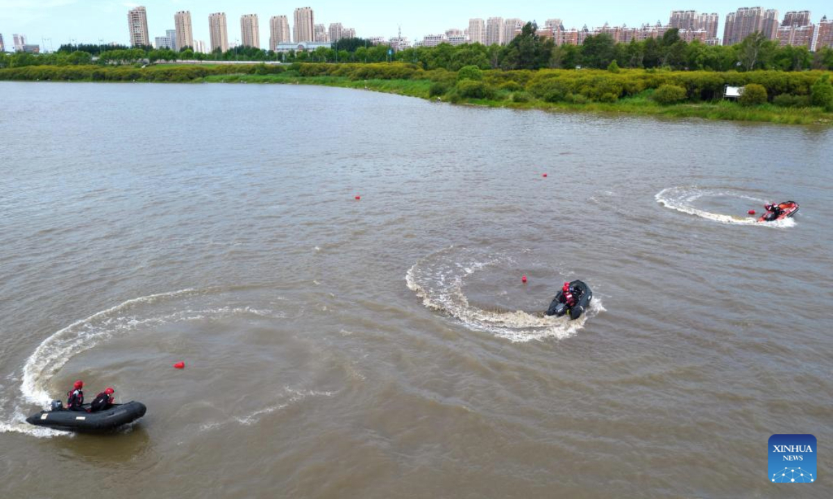 A drone photo taken on Aug. 5, 2025 shows firefighters attending a water surface rescue drill on the Harbin section of Songhua River in northeast China's Heilongjiang Province. The drill was held on Tuesday to improve the emergency response capabilities. (Photo by Yang Tieyan/Xinhua)