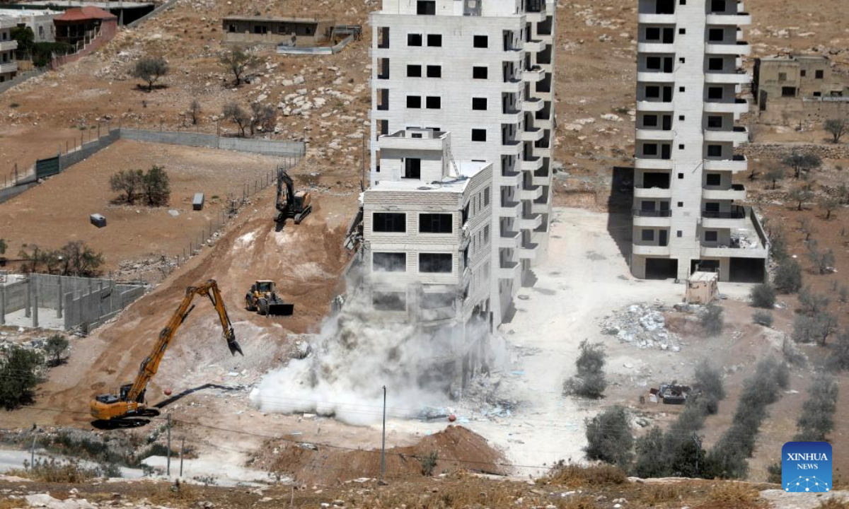 Israeli excavators demolish a building near Dar Salah, east of Bethlehem, in the southern West Bank, on Aug. 6, 2025. (Photo by Mamoun Wazwaz/Xinhua)