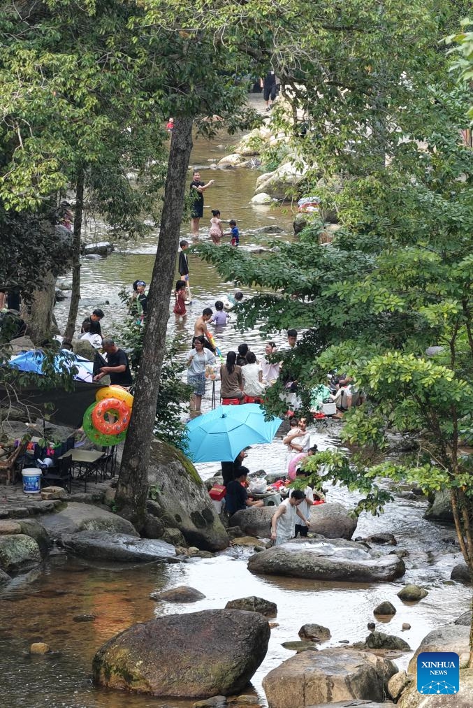 Tourists play in a stream in Nanping Village, Taiping Town, Nanchang City of east China's Jiangxi Province, Aug. 1, 2025.