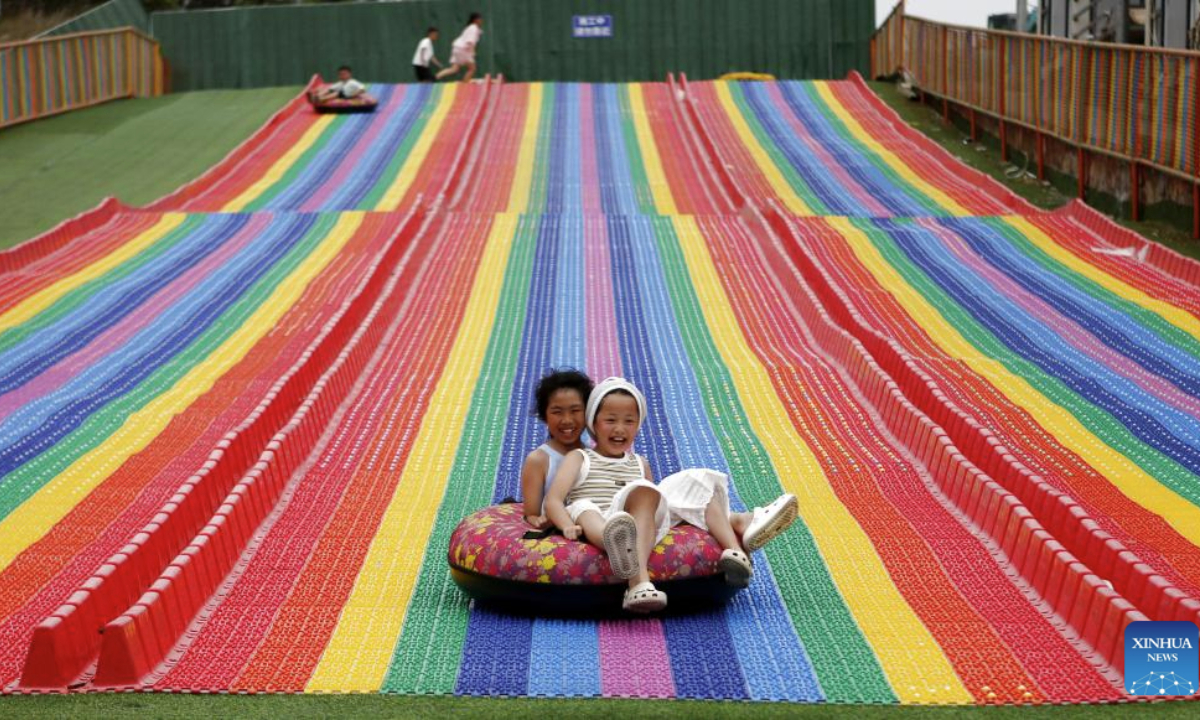 Children have fun at a resort which was once a mine pit in Laixi City, east China's Shandong Province, Aug. 5, 2025. In recent years, local authorities have transformed a closed mine pit into a resort, a move to promote local ecological environment. (Xinhua/Ding Hongfa)