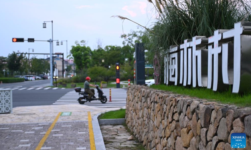 This photo taken on Aug. 4, 2025 shows an entrance to Meilin Village in Xiaoshan District of Hangzhou, east China's Zhejiang Province. Meilin, which has long been a model village for rural development, has been actively exploring ways to reduce pollution and carbon emissions in recent years. Through a series of measures such as promoting rooftop photovoltaic projects, building smart farmlands and integrated photovoltaic charging and storage stations, clean energy is being widely adopted here, injecting green impetus for the rural revitalization. (Xinhua/Mao Zhu)