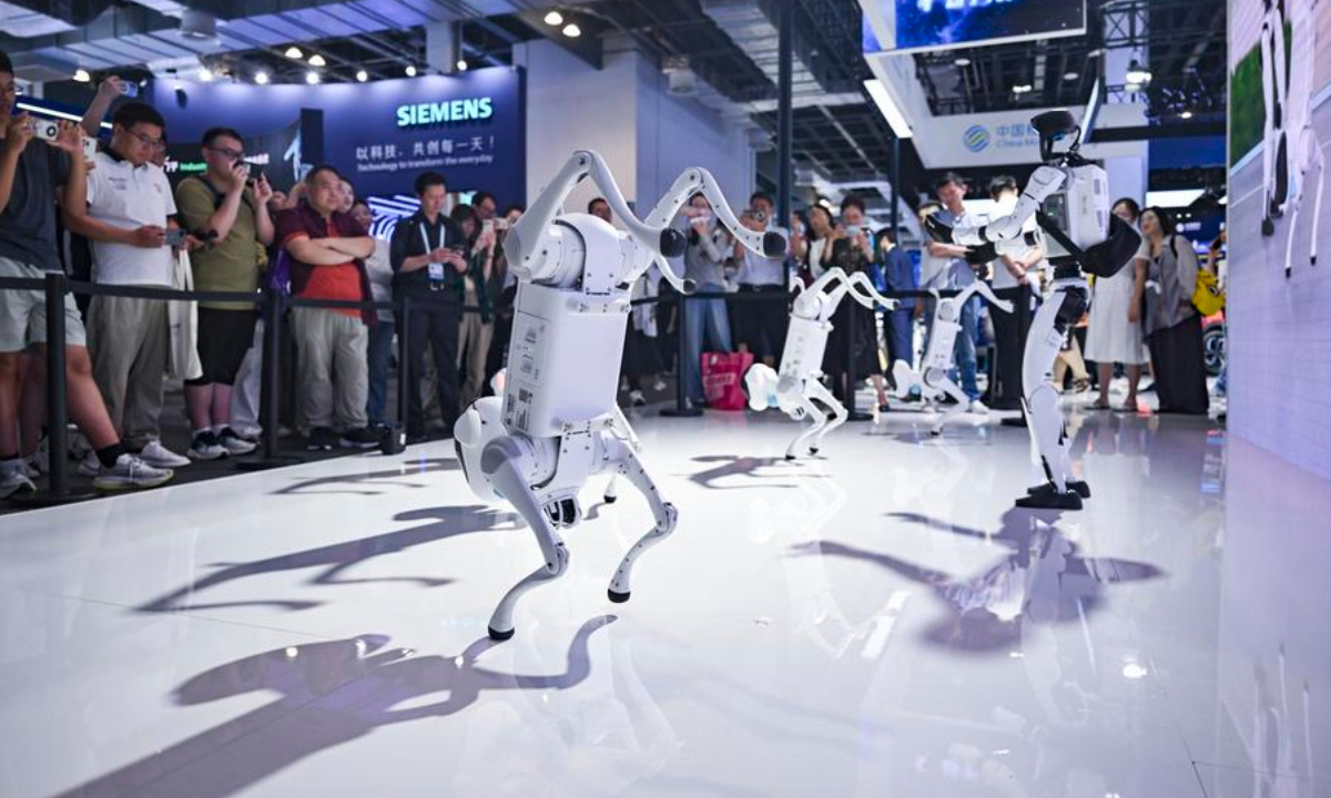 China Mobile's self-developed robot dogs and humanoid robot dance at the company's booth during the 2025 World AI Conference in east China's Shanghai, July 27, 2025. (Xinhua/Chen Haoming)