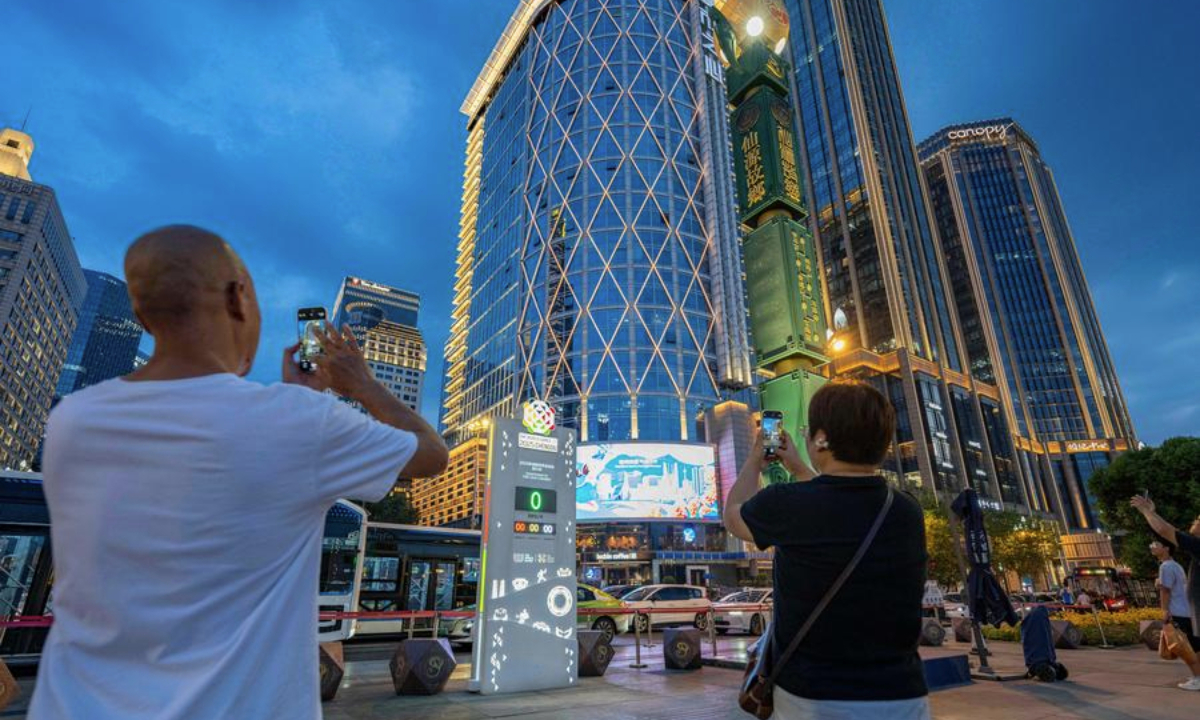 People take photos of a countdown clock in Tianfu Square as the opening ceremony of the World Games 2025 begin in Chengdu, southwest China's Sichuan Province, on Aug. 7, 2025. (Xinhua/Xie Jianfei)