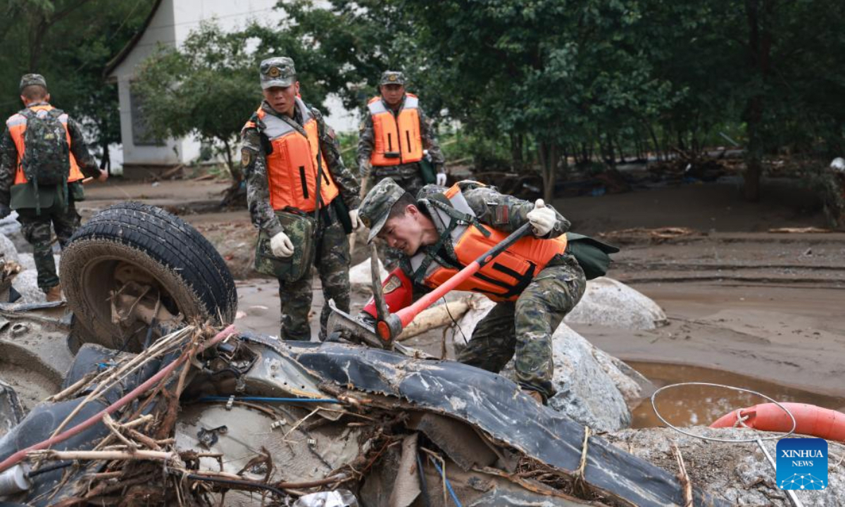 Rescuers search for lost belongings of disaster-affected villagers at a river channel of Yuzhong County, Lanzhou City, northwest China's Gansu Province, Aug. 9, 2025. Rescue efforts are underway after continuous heavy rainfall triggered mountain torrents in Yuzhong County. (Photo by Pei Wenkang/Xinhua)