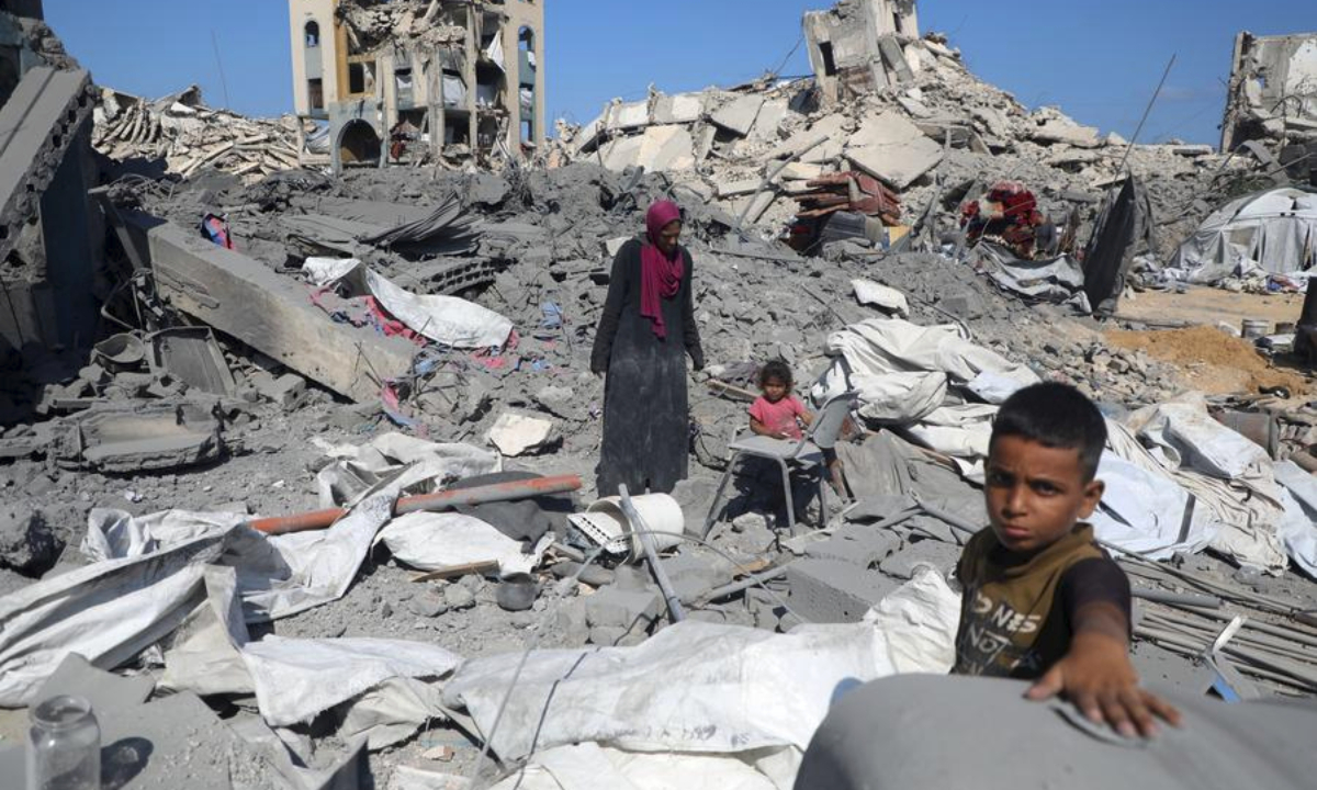 Palestinians are seen among the rubble after an Israeli airstrike in the Sheikh Radwan area, northwest of Gaza City, on Aug. 6, 2025. (Photo: Xinhua)
