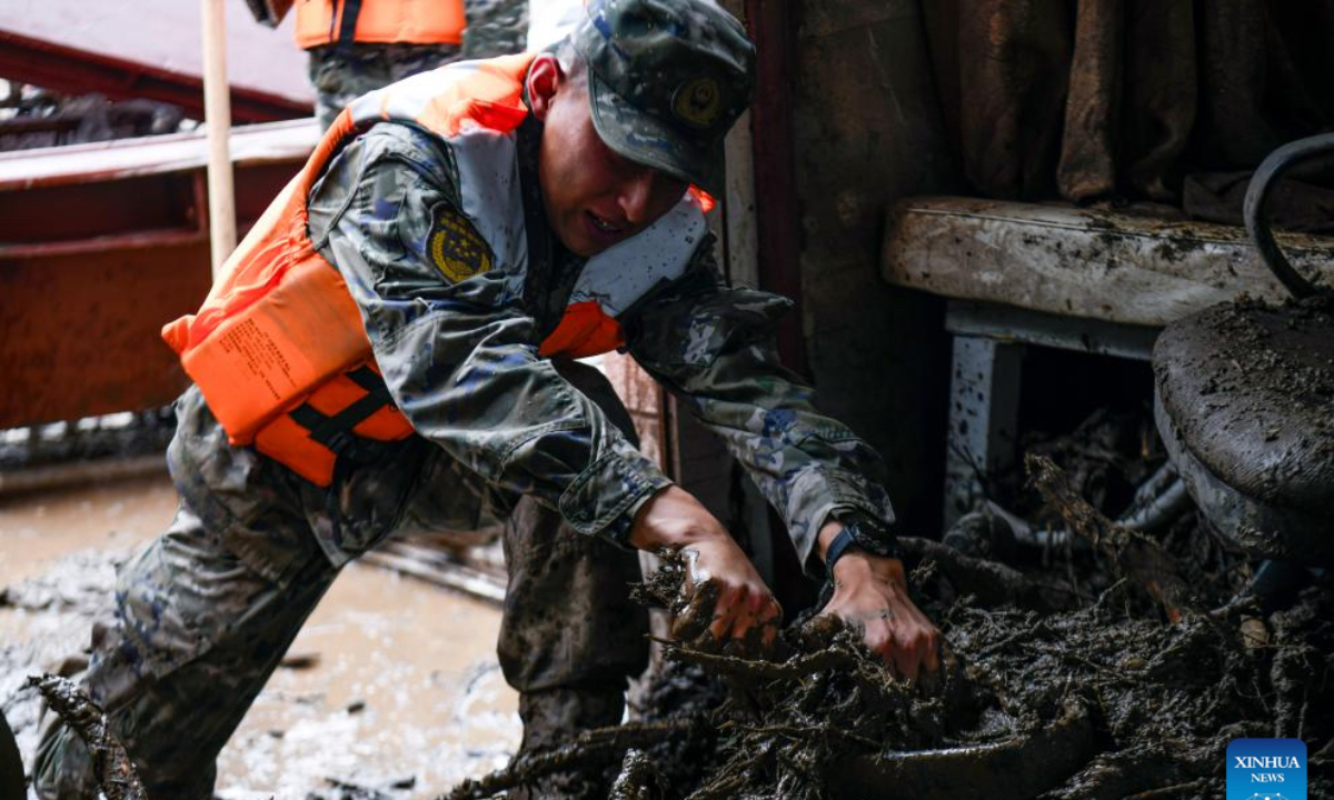 Rescuers clear debris inside the room of disaster-affected villagers in Chengguan Town of Yuzhong County, Lanzhou City, northwest China's Gansu Province, Aug. 9, 2025. Rescue efforts are underway after continuous heavy rainfall triggered mountain torrents in Yuzhong County. (Photo by Hou Chonghui/Xinhua)