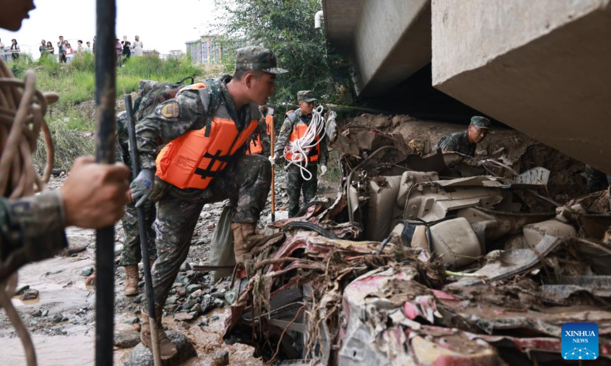 Rescuers search for lost belongings of disaster-affected villagers at a river channel of Yuzhong County, Lanzhou City, northwest China's Gansu Province, Aug. 9, 2025. Rescue efforts are underway after continuous heavy rainfall triggered mountain torrents in Yuzhong County. (Photo by Pei Wenkang/Xinhua)