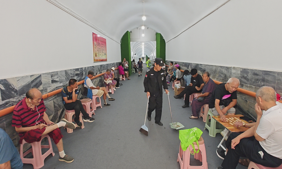 Citizens read, study, play chess and cards inside a wartime air raid shelter in Wuchang District, Wuhan, Central China's Hubei Province, on July 28, 2025.