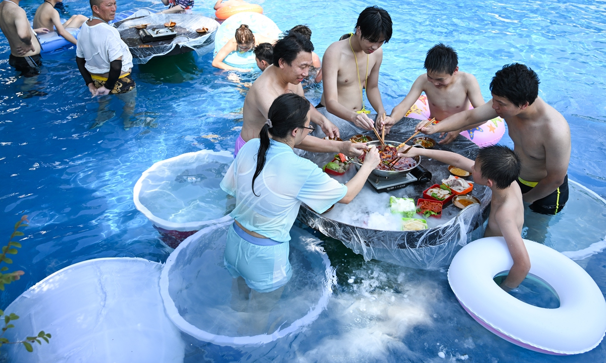 Visitors enjoy hotpot at the water park in Southwest China's Chongqing Municipality, on August 2, 2025. Photos in this page: VCG