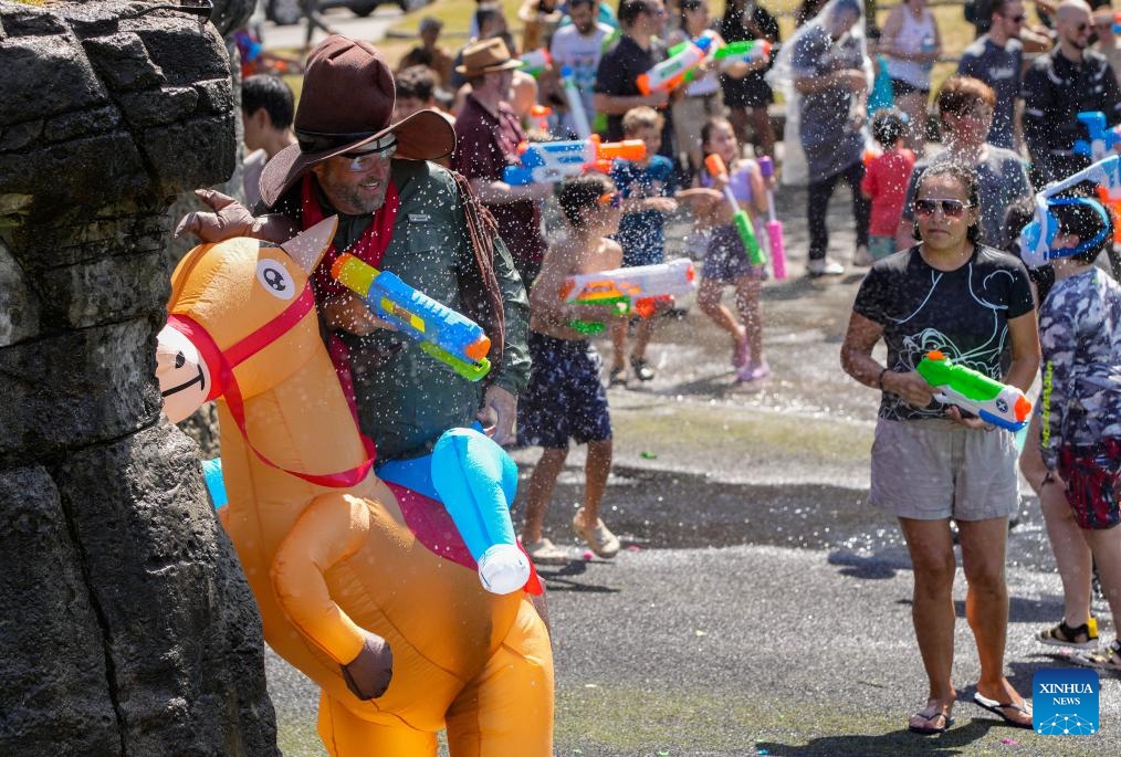 Participants are pictured during the flash mob-style water fight at Stanley Park in Vancouver, British Columbia, Canada, on Aug. 9, 2025. (Photo by Liang Sen/Xinhua)