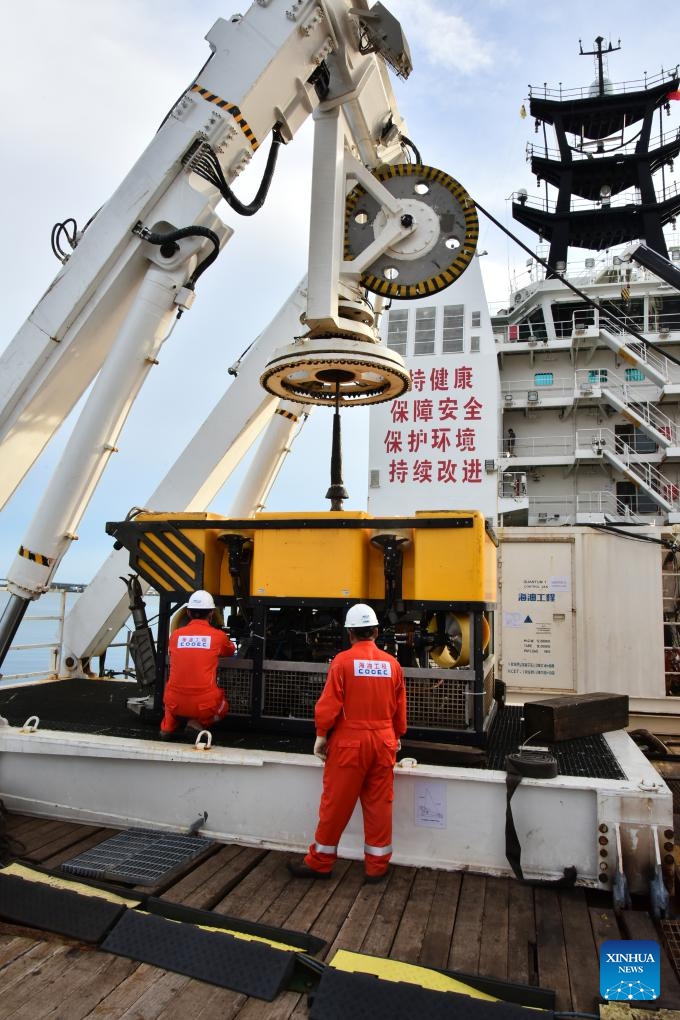 Crew members of China's HYSY 295 trenching vessel inspect the equipment on the vessel at Muara Port in Brunei, Aug. 8, 2025. Designed and built in China, the HYSY 295 trenching vessel is launching its first engineering project mission in Brunei. (Xinhua/Li Meng)