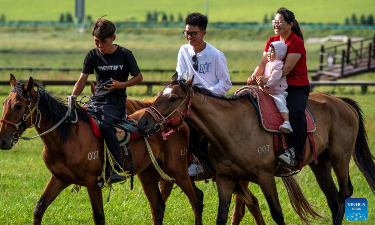 Tourists ride horses at the Wulanmaodu pasture in Horqin Right Wing Front Banner, Hinggan League, north China's Inner Mongolia Autonomous Region, Aug. 9, 2025. (Xinhua/Ma Jinrui)