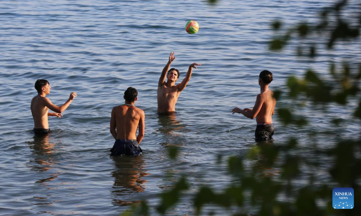 People play volleyball in Lake Bracciano in Italy, Aug. 9, 2025. Italians enjoy various activities during the summer holiday season. (Xinhua/Li Jing)