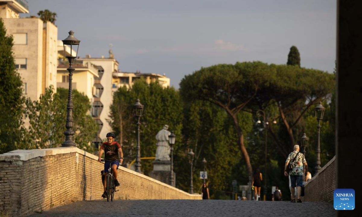 A man rides a bike along the Tiber River in Rome, Italy, Aug. 11, 2025. Italians enjoy various activities during the summer holiday season. (Xinhua/Li Jing)