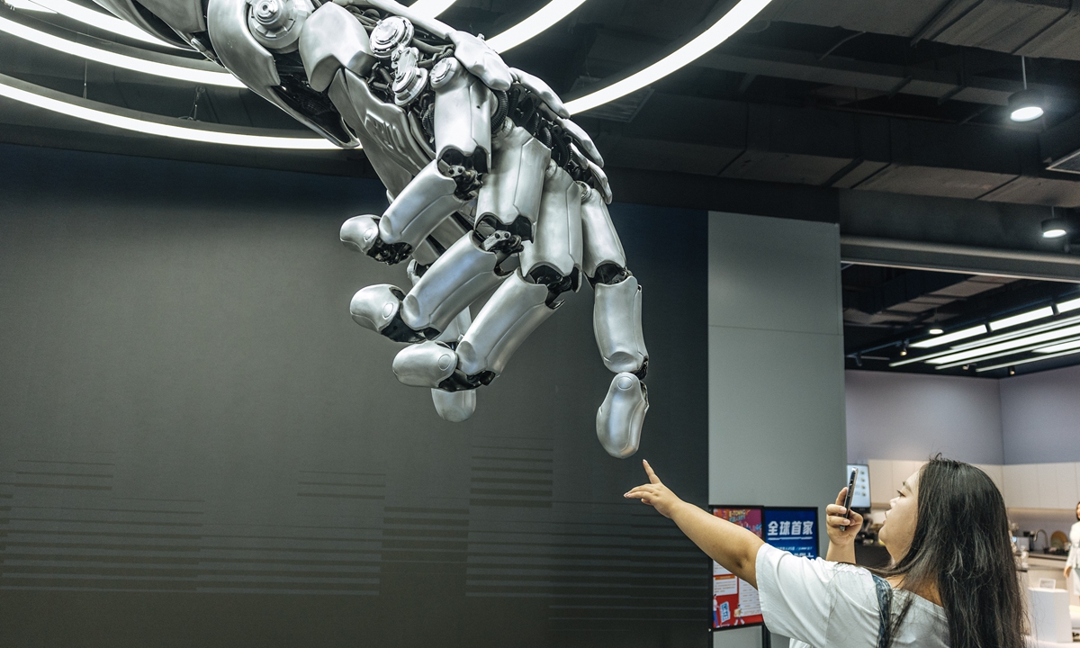 A visitor is interacting with a humanoid robot at the 2025 World Robot Conference on August 9, 2025 in Beijing. Photo: Li Hao/GT