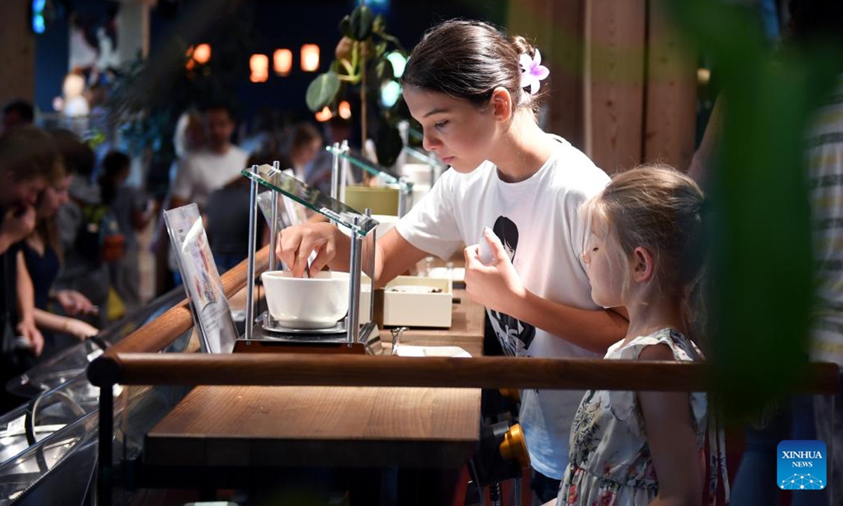 Visitors taste chocolate at Zotter Chocolate Theatre in the town of Bergl, Styria state, Austria, Aug. 6, 2025. Zotter Chocolate Theatre, located in the town of Bergl, Austria's Styria, provides an experience of tasting various flavors and observing chocolate production to all visitors. (Xinhua/He Canling)