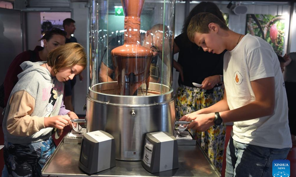 Visitors taste chocolate at Zotter Chocolate Theatre in the town of Bergl, Styria state, Austria, Aug. 6, 2025. Zotter Chocolate Theatre, located in the town of Bergl, Austria's Styria, provides an experience of tasting various flavors and observing chocolate production to all visitors. (Xinhua/He Canling)