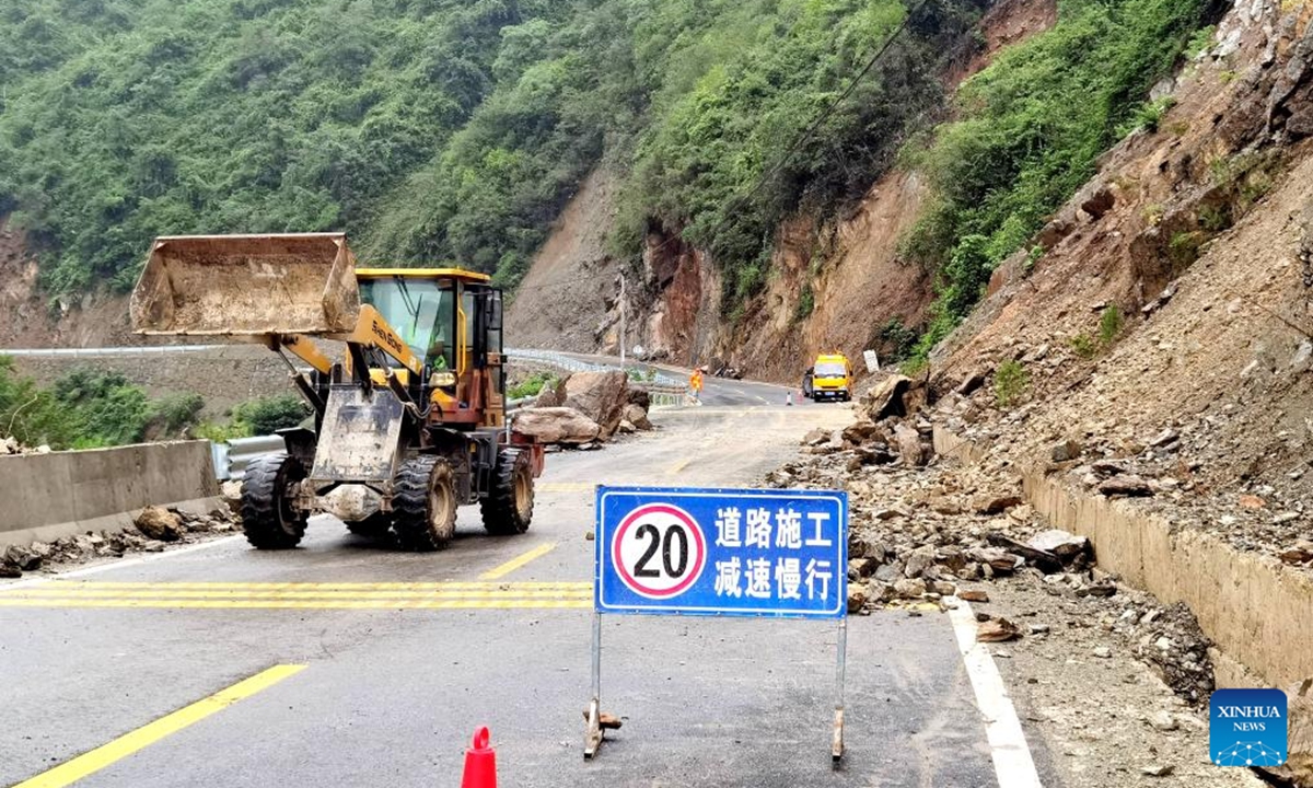 A staff member of the transportation department drives a loader to move rocks on a road in Baokang County, Xiangyang City, central China's Hubei Province, Aug. 10, 2025. Recently, affected by continuous heavy rainfall, many roads in Baokang County were blocked. The transportation department quickly carried out rescue and resumed the weather-disrupted traffic. (Photo by Chen Quanlin/Xinhua)