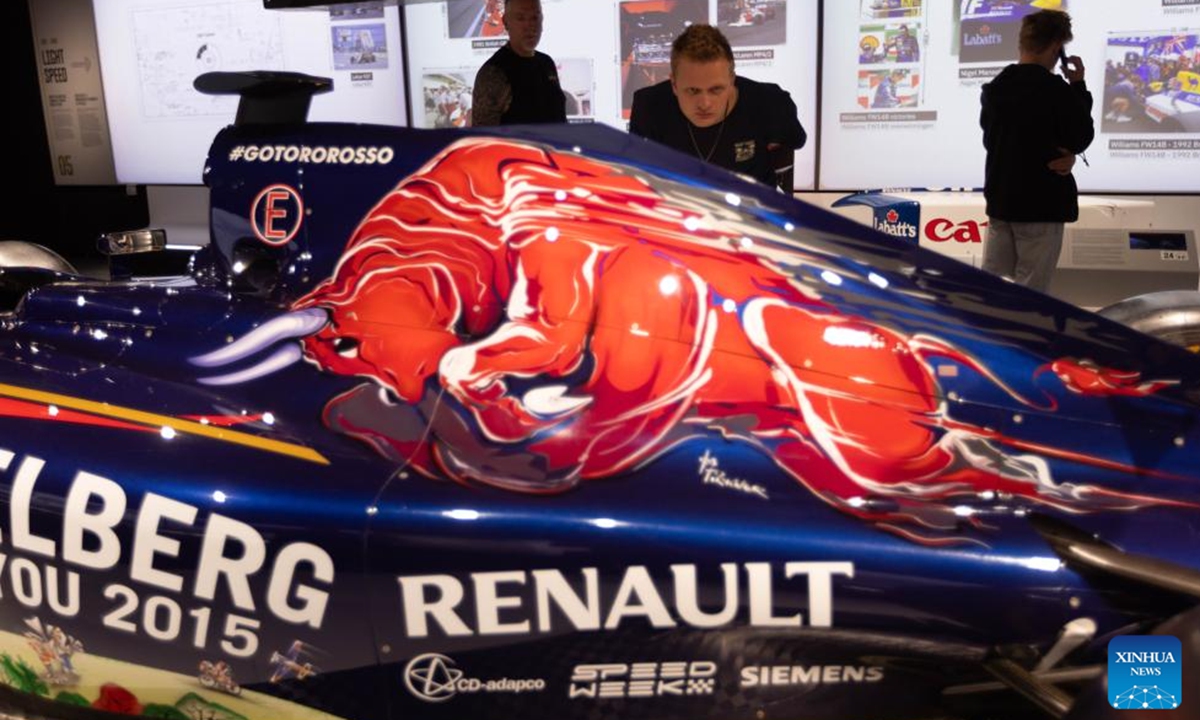 Visitors look at a car during The Formula 1 Exhibition in Amsterdam, the Netherlands, Aug. 9, 2025. The Formula 1 Exhibition in Amsterdam, which opened in April this year, will extend its stay by a final six weeks due to overwhelming public interest. The showcase offers visitors an in-depth look at the world of Formula 1 through immersive displays, historic cars, and behind-the-scenes features. (Photo by Sylvia Lederer/Xinhua)