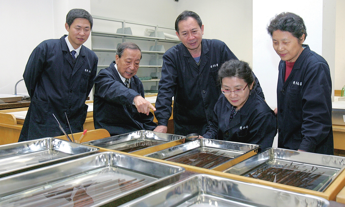 Researchers carry out preliminarily sorting of the  bamboo slips at Tsinghua University. Photo: Courtesy of Tsinghua University's Research and Conservation Center for Unearthed Texts