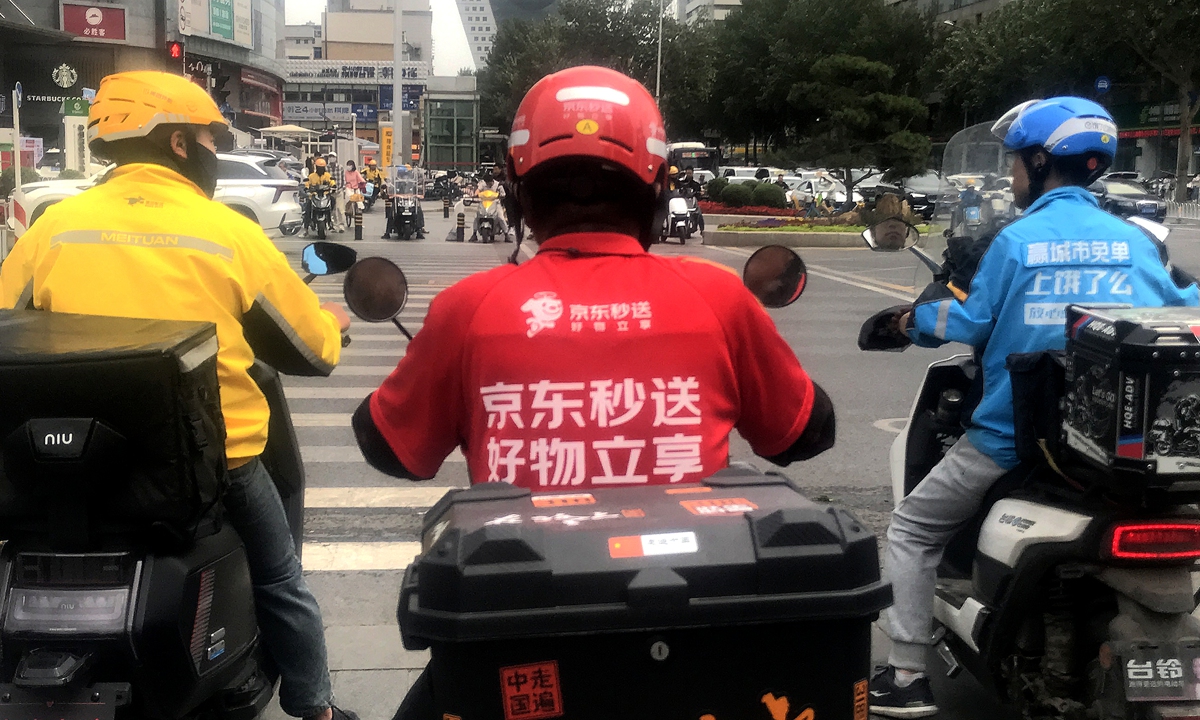 Delivery workers from JD.com, Meituan, and Ele.me meet on a street in Shenyang, Liaoning Province. Photo: CFP