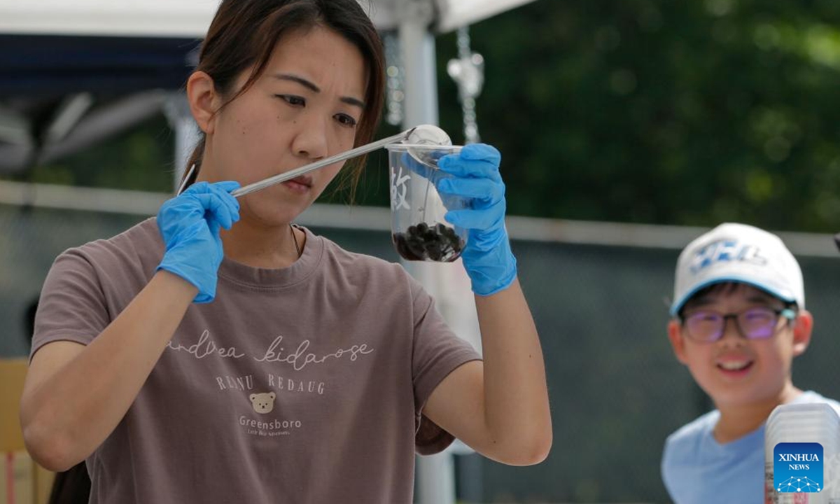 A vendor prepares bubble tea for customers during the 2025 Bubble Tea Festival in Burnaby, British Columbia, Canada, on Aug. 10, 2025. The festival showcases over a hundred kinds of bubble tea, attracting bubble tea lovers to the event. (Photo by Liang Sen/Xinhua)