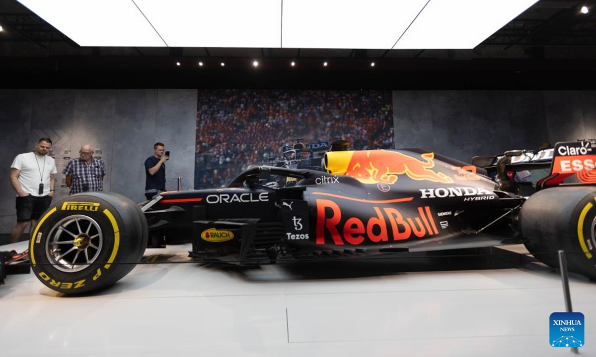 Visitors look at a car during The Formula 1 Exhibition in Amsterdam, the Netherlands, Aug. 9, 2025. The Formula 1 Exhibition in Amsterdam, which opened in April this year, will extend its stay by a final six weeks due to overwhelming public interest. The showcase offers visitors an in-depth look at the world of Formula 1 through immersive displays, historic cars, and behind-the-scenes features. (Photo by Sylvia Lederer/Xinhua)