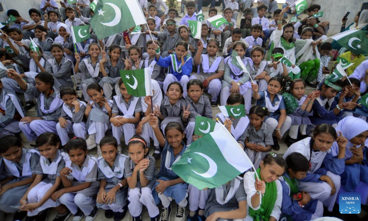 Pakistani students wave national flags during a ceremony at the mausoleum of Pakistan's founder Muhammad Ali Jinnah to mark the country's Independence Day in southern Pakistani port city of Karachi on Aug. 14, 2025. (Str/Xinhua)