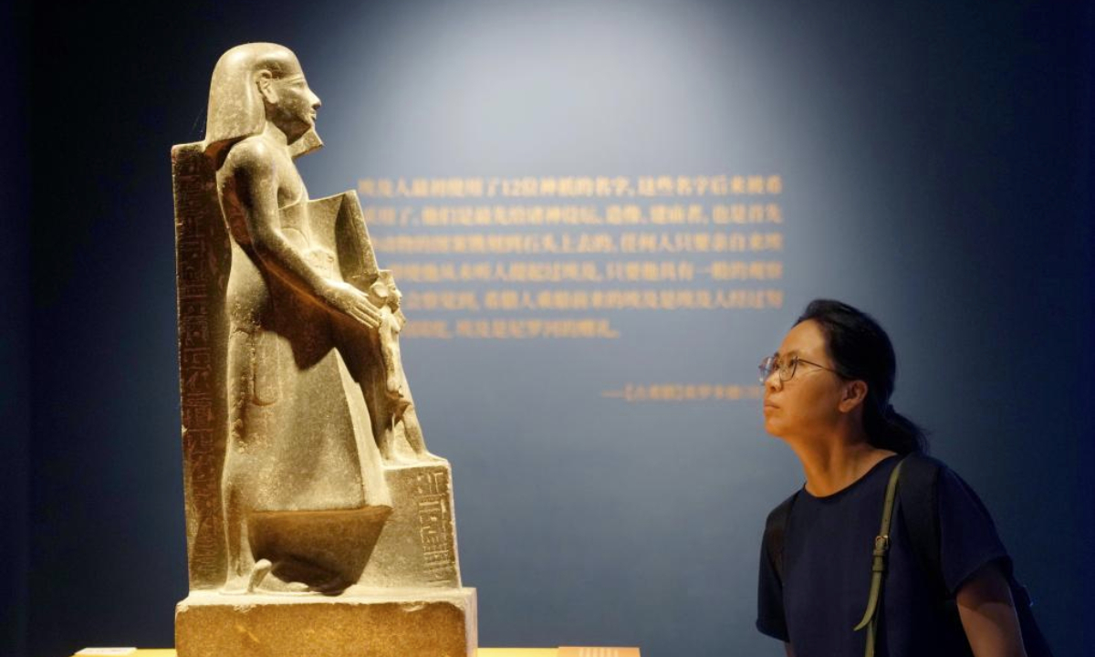 A woman visits the exhibition On Top of the Pyramid: The Civilization of Ancient Egypt at the Shanghai Museum at night in Shanghai, east China, Aug. 11, 2025. The exhibition, titled On Top of the Pyramid: The Civilization of Ancient Egypt, opens 24 hours a day from Aug. 11 to 17 at the Shanghai Museum. During the 168-hour carnival, there will also be new books releases, Egyptian dancing performances, interactive games and cultural and creative production promotions here. (Xinhua/Liu Ying)
