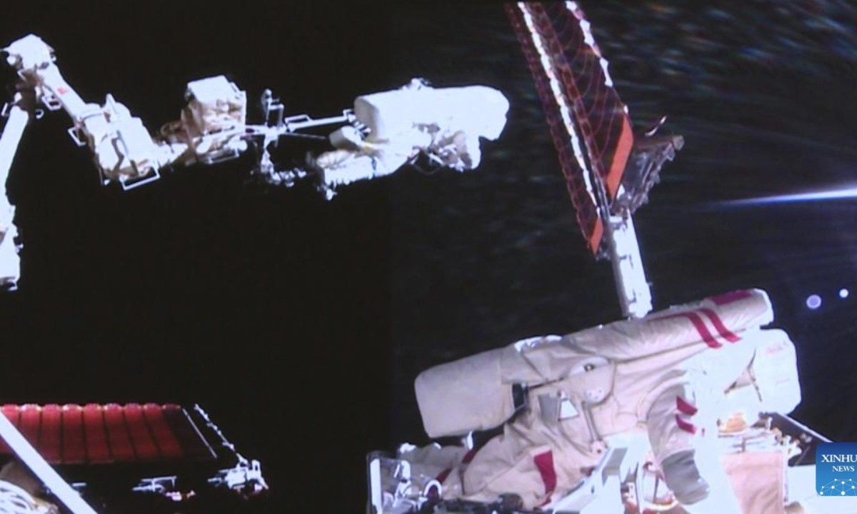 This video snapshot captured at Beijing Aerospace Control Center on Aug. 15, 2025 shows Shenzhou-20 astronauts Chen Dong (L) and Wang Jie performing extravehicular activities outside China's orbiting space station. The Shenzhou-20 crew aboard China's orbiting space station completed their mission's third series of extravehicular activities on Friday, according to the China Manned Space Agency (CMSA).(Xinhua/Yin Jiajie)