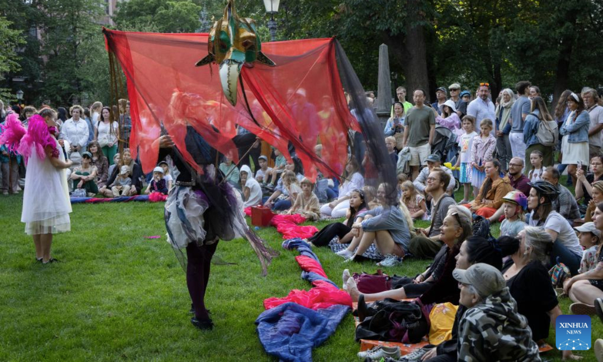 People watch an art performance during the Night of the Arts in Helsinki, Finland, Aug. 14, 2025. The event was held here on Thursday, featuring more than 370 free art and cultural activities, including music, dance, theater, painting, literature and other art forms. (Photo by Matti Matikainen/Xinhua)