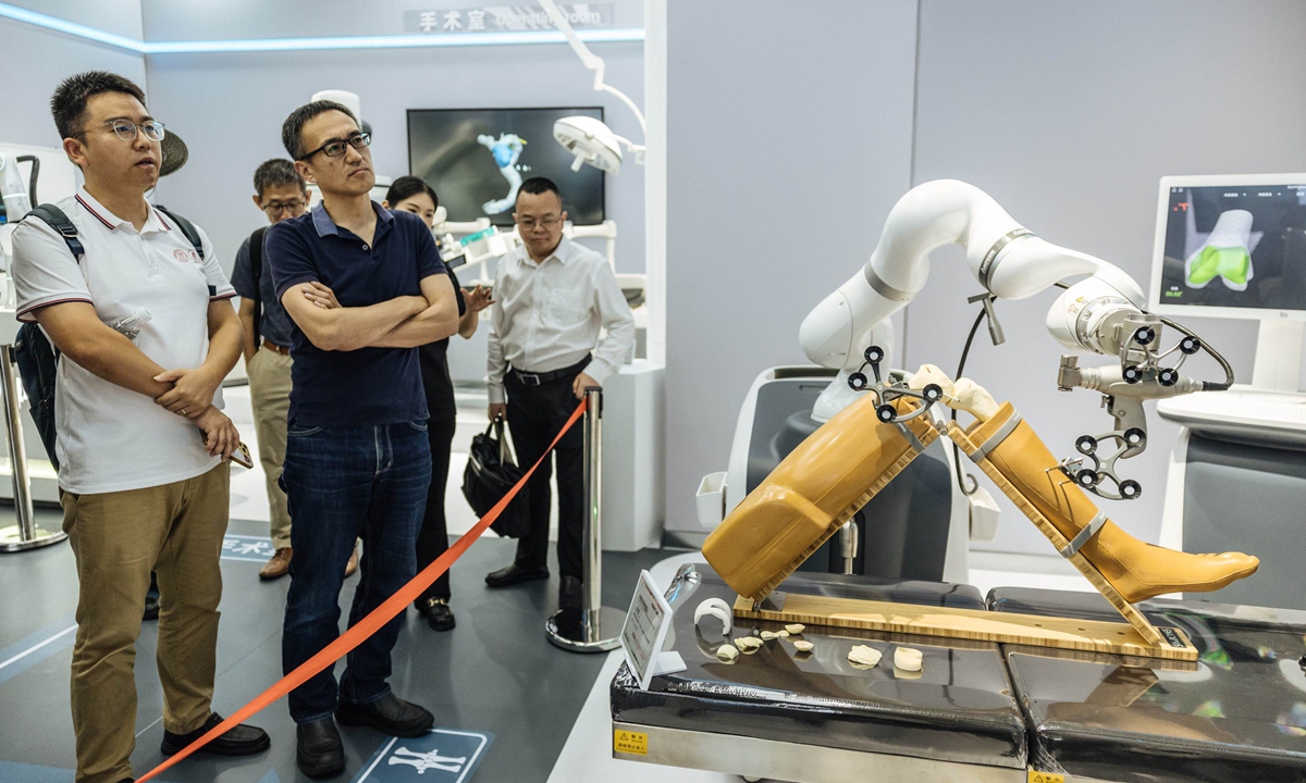 Visitors watch a medical robot at the world's first robot 4S store in Yizhuang, Beijing, on August 7, 2025. Photo: Li Hao/GT