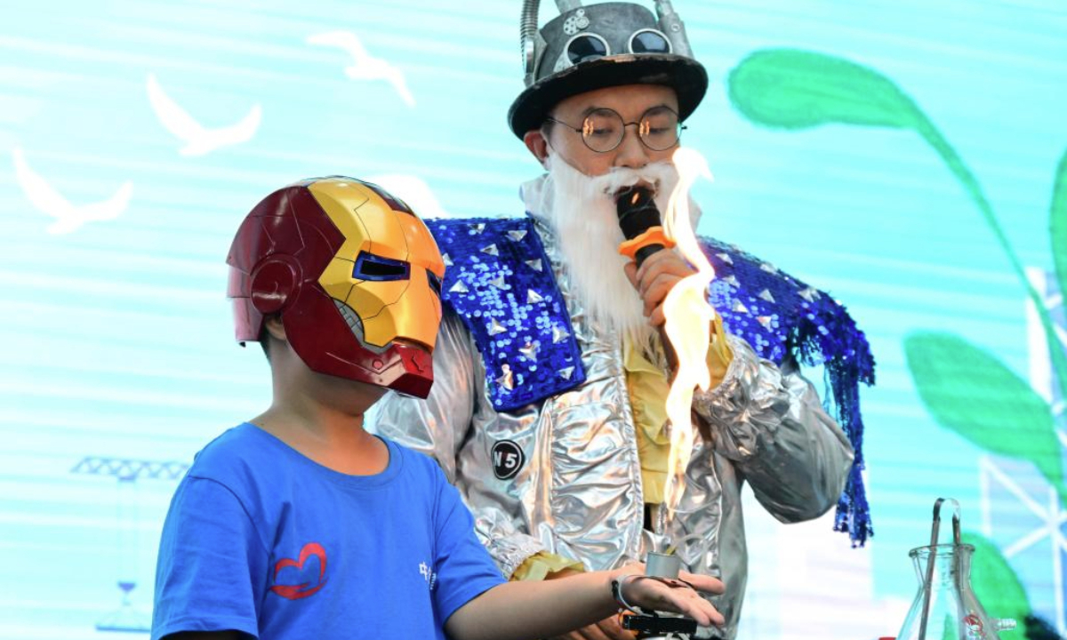 A child participates in an interactive science experiment in Qingdao, east China's Shandong Province, Aug. 12, 2025. Children across China take part in various kinds of activities to spend their summer holiday. (Xinhua/Li Ziheng)