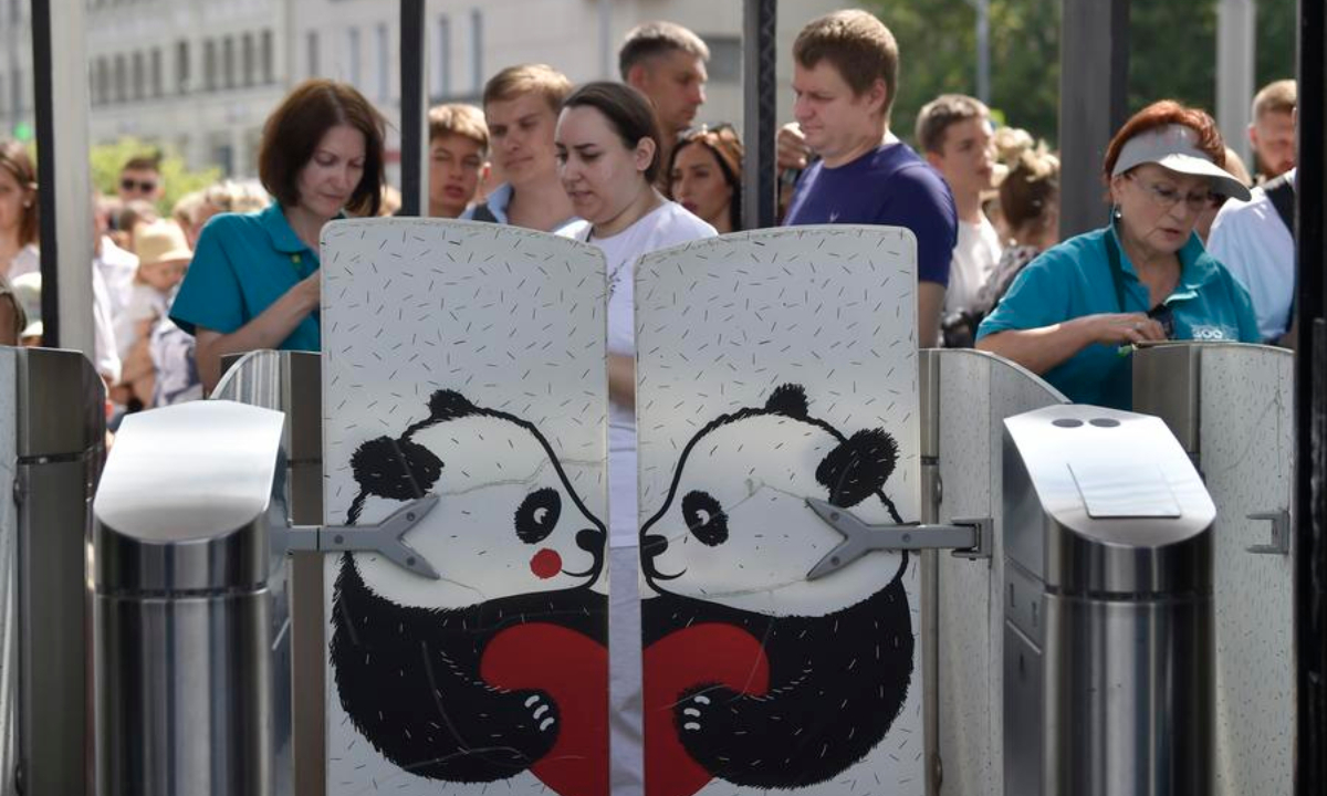 People wait to attend a birthday celebration for giant panda Dingding at the Moscow Zoo in Moscow, Russia, on July 30, 2025. (Photo by Alexander Zemlianichenko Jr/Xinhua)